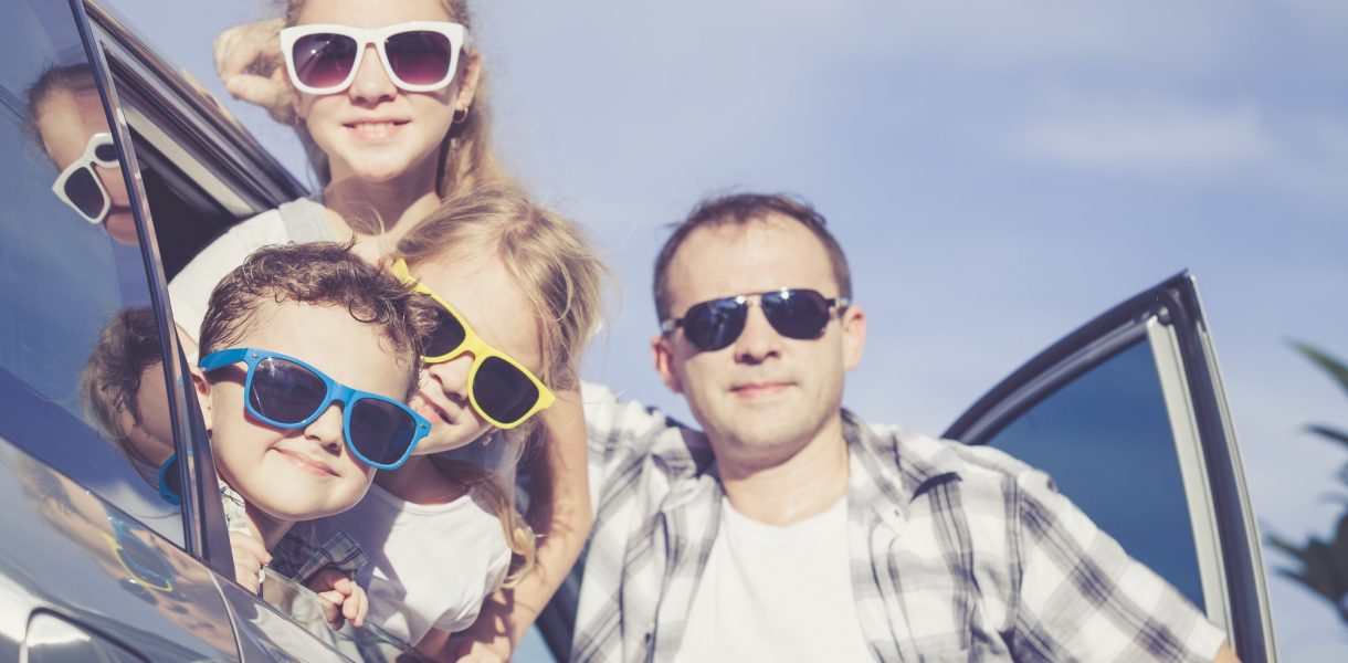 Happy family getting ready for road trip on a sunny day
