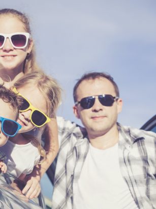 Happy family getting ready for road trip on a sunny day