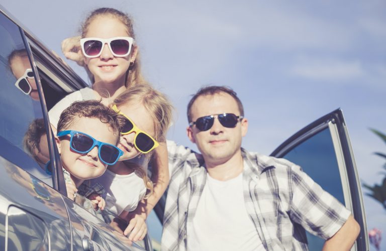 Happy family getting ready for road trip on a sunny day